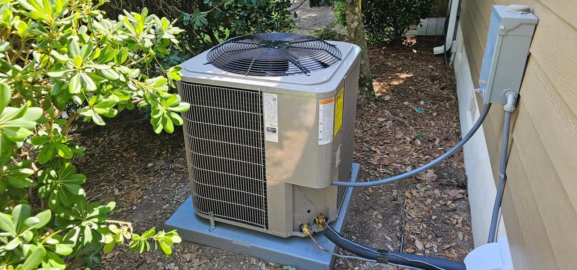 hvac unit installed on a residential house backyard landscape